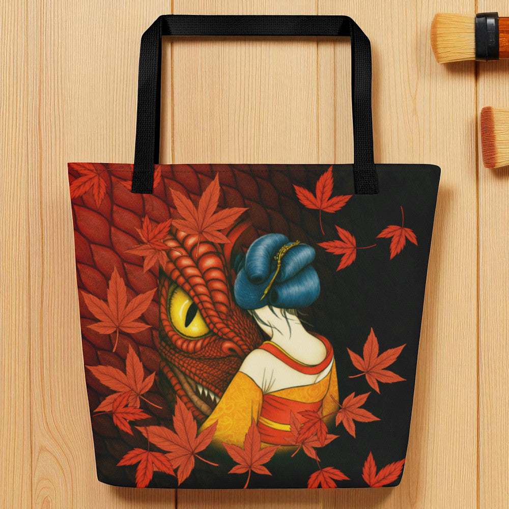 Vista frontal del bolso con geisha y hojas rojas, encuadre cercano, asas negras.