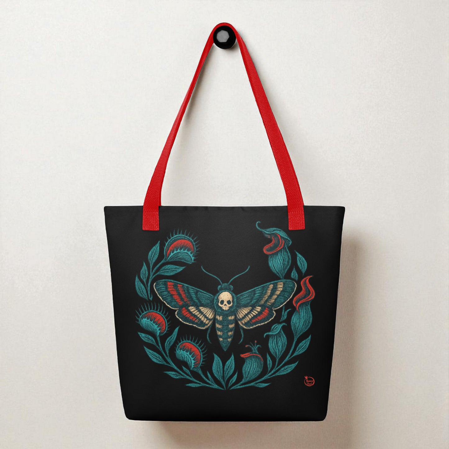 Bolso tote negro con ilustración de polilla calavera, vista frontal con asas rojas.