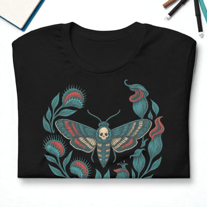 Camiseta eco unisex negra en vista cenital con diseño de polilla calavera y hojas.