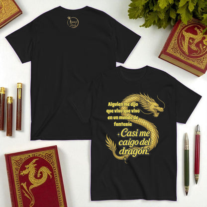 Camiseta negra unisex con dragon dorado y frase Casi me caigo del dragon en composicion flatlay
