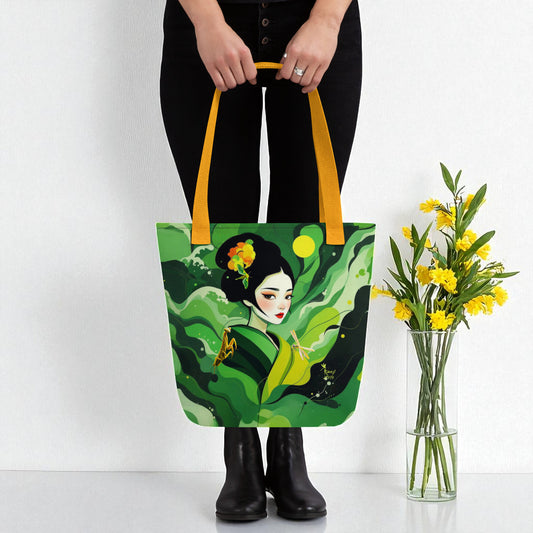 Bolso tote Geisha Esperanza con asas amarillas, ilustración japonesa exclusiva Kuzen Saha, junto a ramo de flores amarillas.