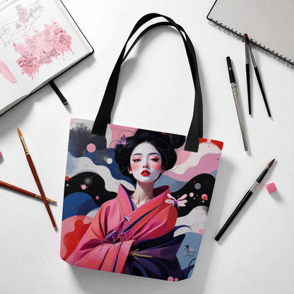 Bolso tote Geisha Rosa con asas negras, colocado sobre escritorio junto a cuaderno y accesorios de oficina, estilo moderno y artístico.