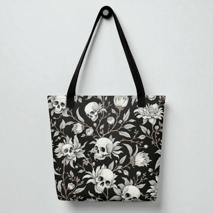 Bolso tote de hombro negro con estampado de calaveras y flores, vista frontal, asas negras