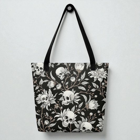 Bolso tote de hombro negro con estampado de calaveras y flores, vista frontal, asas negras