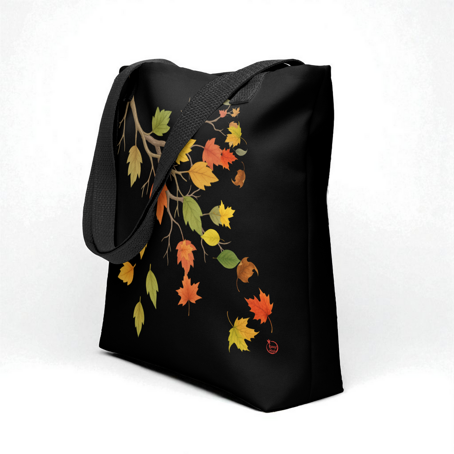 Bolso tote negro con estampado de hojas otoñales y asas negras, vista 3/4